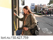 sideways passenger entering tram. Стоковое фото, агентство Ingram Publishing / Фотобанк Лори