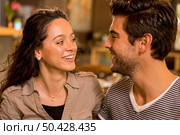 A beautiful and young couple looking each other. Стоковое фото, агентство Ingram Publishing / Фотобанк Лори