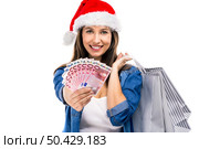 Beauitful woman holding shopping bags and some Euro currency notes, isolated over white background. Santa woman with money and shopping bags. Стоковое фото, агентство Ingram Publishing / Фотобанк Лори