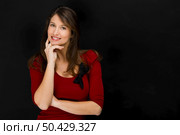 Beautiful young student smiling over a black chalkboard. Стоковое фото, агентство Ingram Publishing / Фотобанк Лори