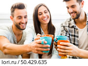 Group of friends making a toast with coffee. Стоковое фото, агентство Ingram Publishing / Фотобанк Лори