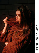 medium shot woman holding sweater. Стоковое фото, агентство Ingram Publishing / Фотобанк Лори