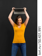 Angry woman trowing her laptop into the floor. Стоковое фото, агентство Ingram Publishing / Фотобанк Лори