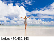 Beautiful woman on the beach enjoying the beauty of Praslin, Seychelles. Стоковое фото, агентство Ingram Publishing / Фотобанк Лори