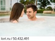 Young couple in a luxury hotel inside a jacuzzi enjoying the holidays. Стоковое фото, агентство Ingram Publishing / Фотобанк Лори