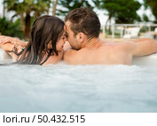 Young couple in a luxury hotel  inside a jacuzzi and kissing. Стоковое фото, агентство Ingram Publishing / Фотобанк Лори