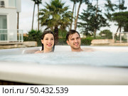 Young couple in a luxury hotel inside a jacuzzi in a rainy day . Стоковое фото, агентство Ingram Publishing / Фотобанк Лори