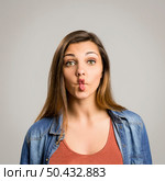 Portrait of a beautiful woman making a pout expression. Стоковое фото, агентство Ingram Publishing / Фотобанк Лори