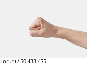 Male hand clenched fist pain down, isolated on a white background.. Aggressive symbol of man hand in fist. Стоковое фото, агентство Ingram Publishing / Фотобанк Лори