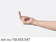 Female hand with provocative middle finger sideways offensive gesture isolated on white background. Gesture of aggression or disrespect.. Female hand with provocative middle finger isolated on white. Стоковое фото, агентство Ingram Publishing / Фотобанк Лори