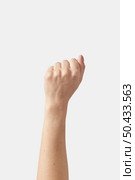 Woman hand clenched fist raised up in victory, isolated on a white background.. Fist up, victory symbol female hand. Стоковое фото, агентство Ingram Publishing / Фотобанк Лори
