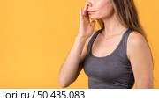 side view woman holding nostril. Стоковое фото, агентство Ingram Publishing / Фотобанк Лори