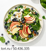 Apple and spinach fresh sweet fruit salad with blueberry, cheese cottage and walnuts, top view. Стоковое фото, агентство Ingram Publishing / Фотобанк Лори