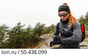 female sporty jogger looking her smartwatch. Стоковое фото, агентство Ingram Publishing / Фотобанк Лори