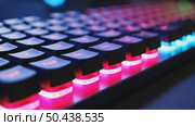 Close up of professional gaming keyboard with colorful LED backlight in multiple colors. Technology in gaming or developer industry. Desktop computer accessories. Стоковое AI-видео, аниматор Sergey Grishin / Фотобанк Лори