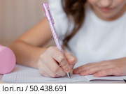 little girl taking notes online class. Стоковое фото, агентство Ingram Publishing / Фотобанк Лори
