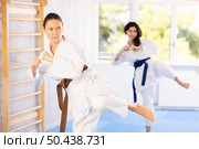 Woman in kimono standing in fight stance during group karate training. Стоковое фото, фотограф Яков Филимонов / Фотобанк Лори