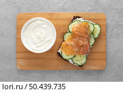 top view sandwich with cucumbers salmon cutting board. Стоковое фото, агентство Ingram Publishing / Фотобанк Лори