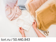 elevated view fashion designer s hand working fabrics studio. Стоковое фото, агентство Ingram Publishing / Фотобанк Лори