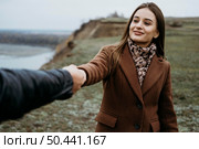 front view woman dragging her boyfriend along outdoors. Стоковое фото, агентство Ingram Publishing / Фотобанк Лори