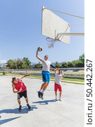 street basketball athlete performing huge slam dunk court. Стоковое фото, агентство Ingram Publishing / Фотобанк Лори