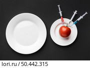 tomato injected with gmo chemicals. Стоковое фото, агентство Ingram Publishing / Фотобанк Лори