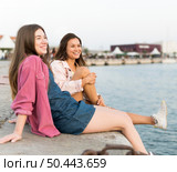 female friends resting together by lake. Стоковое фото, агентство Ingram Publishing / Фотобанк Лори