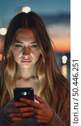 Beautiful young woman use smartphone at night. Millennial generation z female scroll through news feed on app on her phone. Cinematic film look photo of pretty girl. Стоковое AI-видео, аниматор Sergey Grishin / Фотобанк Лори