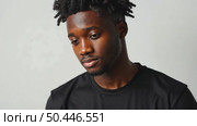 Attractive sexy African American young man wearing a blank cotton black t-shirt isolated on white studio background. Стоковое AI-видео, аниматор Sergey Grishin / Фотобанк Лори