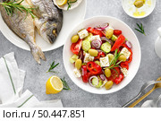 Greek salad, baked dorada fish sea bream and tzatziki dip. Healthy food. Mediterranean diet. Стоковое фото, агентство Ingram Publishing / Фотобанк Лори