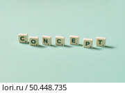 Concept word formed of scrabble elements shadow falling on turquoise background. Minimal business design with place for text.. Concept formed of scrabble elements on turquoise background. Стоковое фото, агентство Ingram Publishing / Фотобанк Лори