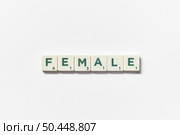 Female word formed of scrabble elements on white background. Creative template with awareness concept.. Female formed of scrabble elements on white background. Стоковое фото, агентство Ingram Publishing / Фотобанк Лори