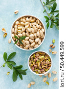 Pistachios. Whole pistachios with green leaves and pistachio nut kernels. Healthy natural vegetarian organic food. Top view, copy space. Стоковое фото, агентство Ingram Publishing / Фотобанк Лори
