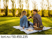 Shot of a happy couple enjoying a day in the park and making a toast. Стоковое фото, агентство Ingram Publishing / Фотобанк Лори