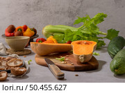 Autumn vegetables arranged on a kitchen worktop while preparing a pumpkin soup. Стоковое фото, агентство Ingram Publishing / Фотобанк Лори
