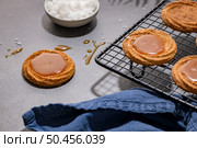 Caramel cookies flowing out of the oven, in the kitchen after baking. Стоковое фото, агентство Ingram Publishing / Фотобанк Лори