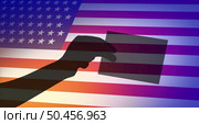 American election voter and community vote or US voting diversity concept as a shadow of a person casting a United States ballot at a polling station as a USA democratic right in a democracy with 3D illustration style. Стоковое фото, агентство Ingram Publishing / Фотобанк Лори