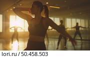 A group of individuals moving in synchronized patterns, dancing energetically in a dance studio filled with mirrors and ballet bars. Стоковое AI-изображение, AI-художник Данила Большаков / Фотобанк Лори