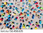 Aerial view of colorful umbrellas on sandy beach, people at sunset in summer in Sardinia, Italy. Tropical landscape. Travel and vacation. Top down view from drone. Tropical pattern. Concept. Стоковое фото, агентство Ingram Publishing / Фотобанк Лори