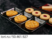 Many cookies are beautifully arranged in a plate and then placed on a wooden table. Стоковое фото, агентство Ingram Publishing / Фотобанк Лори