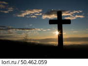 Silhouette of catholic cross and sunrise. Стоковое фото, агентство Ingram Publishing / Фотобанк Лори