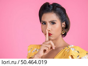 Beauty asian woman red lips and finger showing hush silence sign. Стоковое фото, агентство Ingram Publishing / Фотобанк Лори