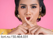 Beauty asian woman red lips and finger showing hush silence sign. Стоковое фото, агентство Ingram Publishing / Фотобанк Лори