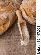 Rustic bread and wheat on an old vintage planked wood table. Стоковое фото, агентство Ingram Publishing / Фотобанк Лори