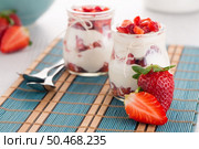 Strawberries desert with cream served on glass cups over table top. Стоковое фото, агентство Ingram Publishing / Фотобанк Лори