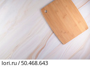 Top view of wooden cutting board on a gray marble background with space for text. Стоковое фото, агентство Ingram Publishing / Фотобанк Лори