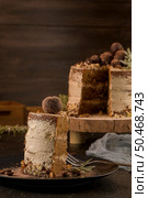 Slice of delicious naked coffee and hazelnuts cake on table rustic wood kitchen countertop. Стоковое фото, агентство Ingram Publishing / Фотобанк Лори