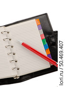 Open note book with lined pages free date space and red pencil. Стоковое фото, агентство Ingram Publishing / Фотобанк Лори