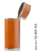 Orange lighter case on white reflective background. Стоковое фото, агентство Ingram Publishing / Фотобанк Лори