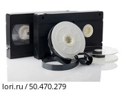 Two videotapes and reel on  white reflective background. Стоковое фото, агентство Ingram Publishing / Фотобанк Лори